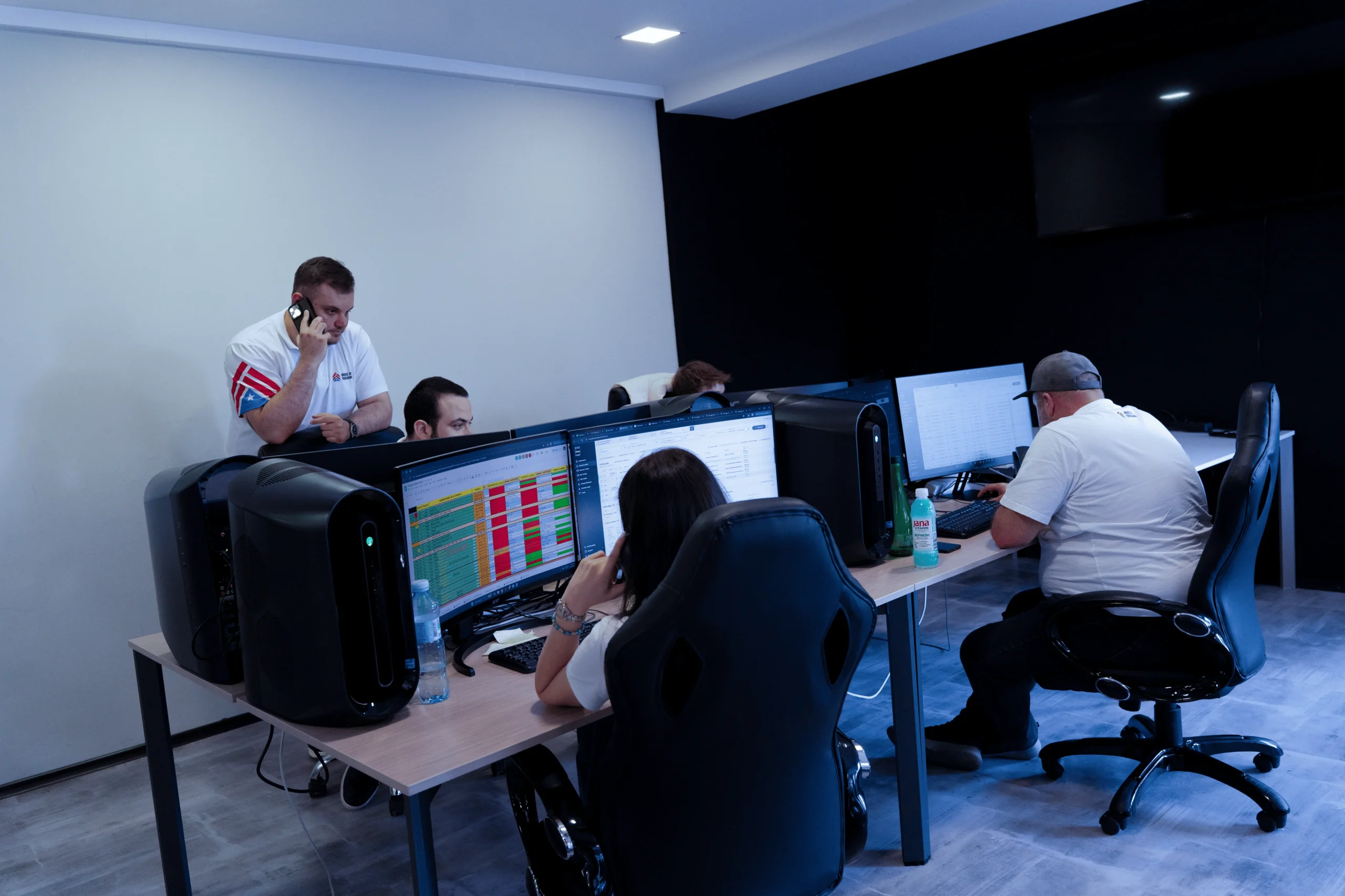 House of Trucking dispatch team working at multiple computer screens
