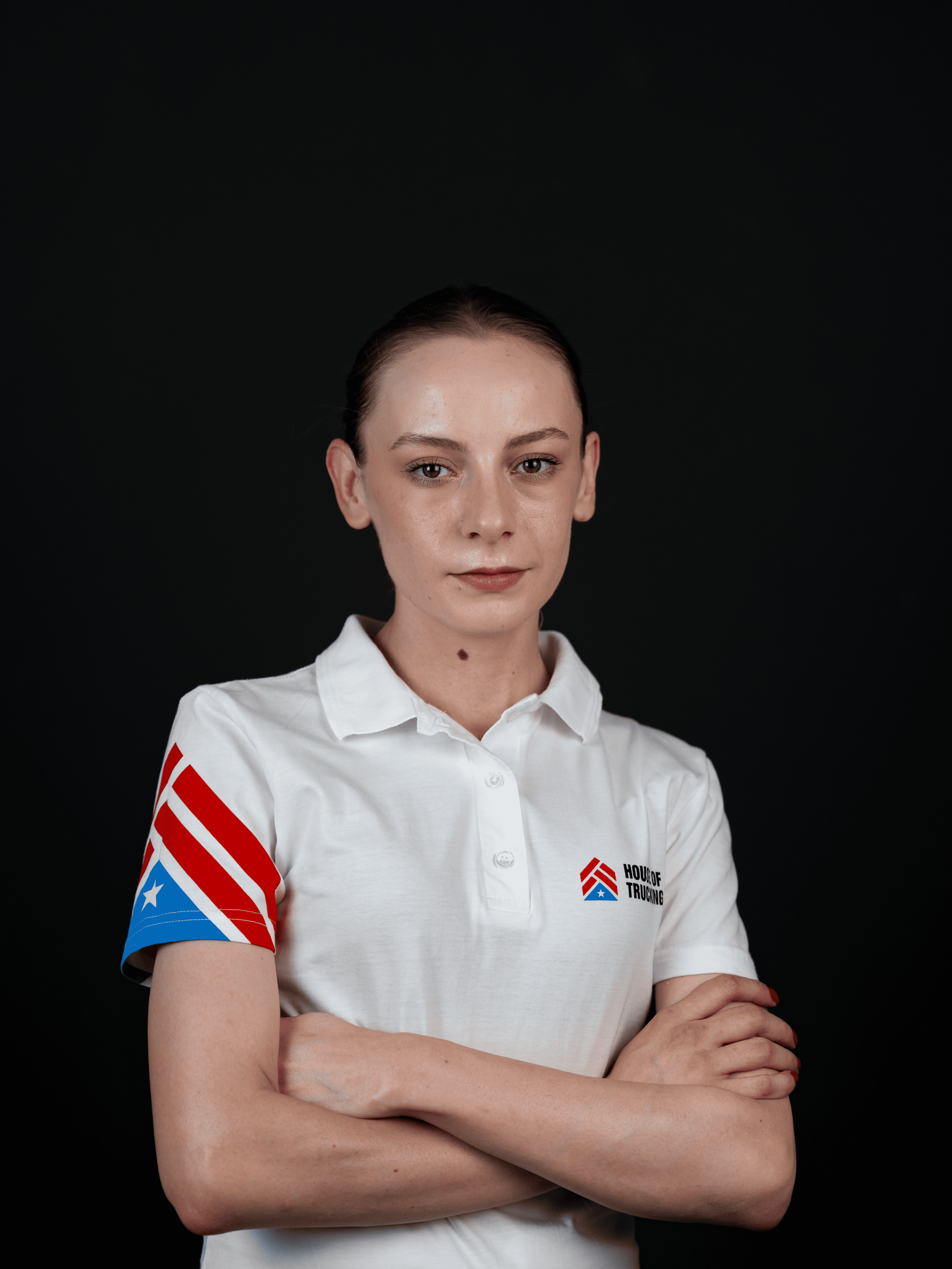 Kate, Elite Driver Recruiter at House of Trucking, confident team member in company uniform.
