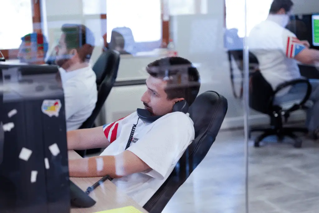 Dispatcher handling calls and managing logistics tasks at House of Trucking office