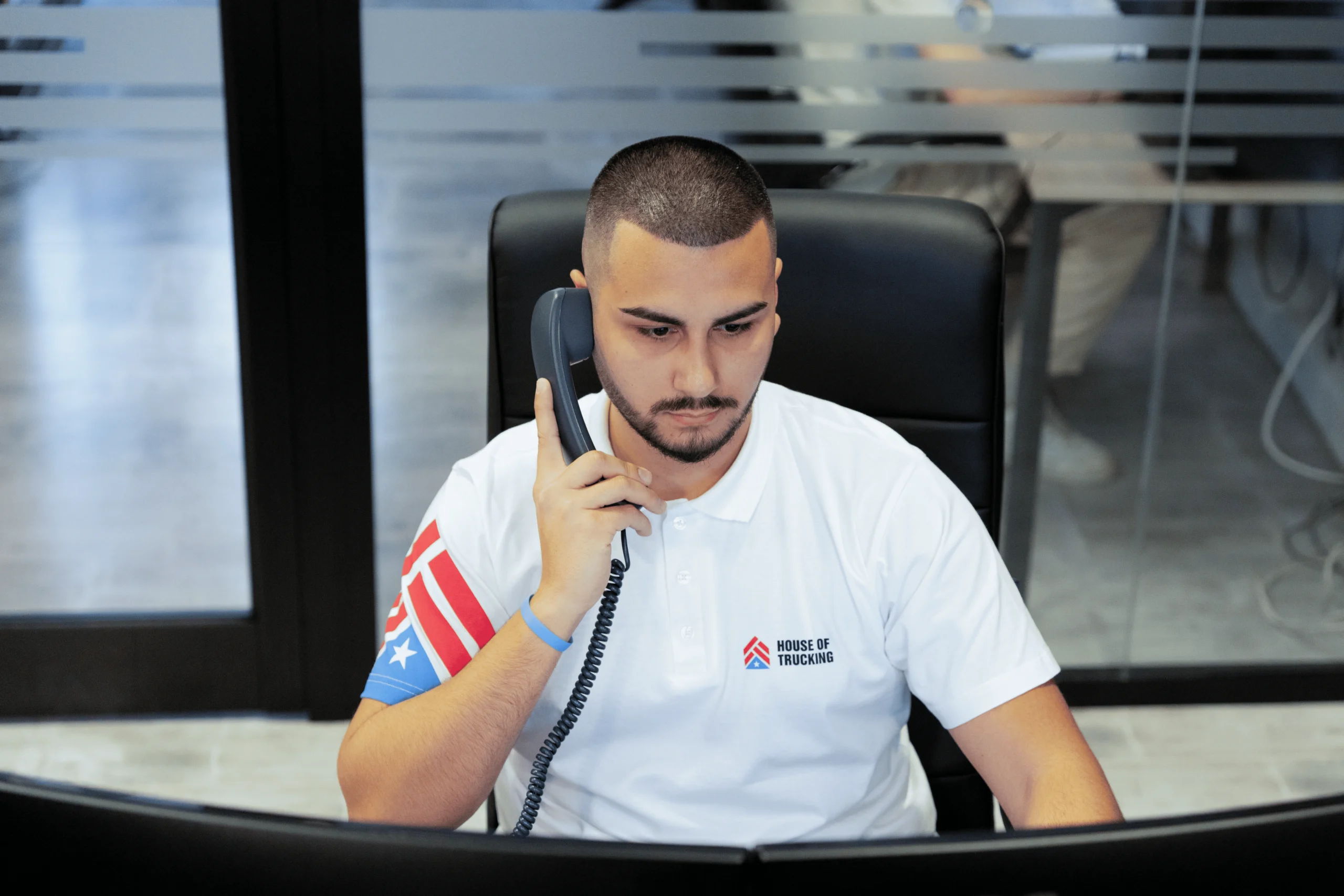 House of Trucking compliance officer handling a phone call
