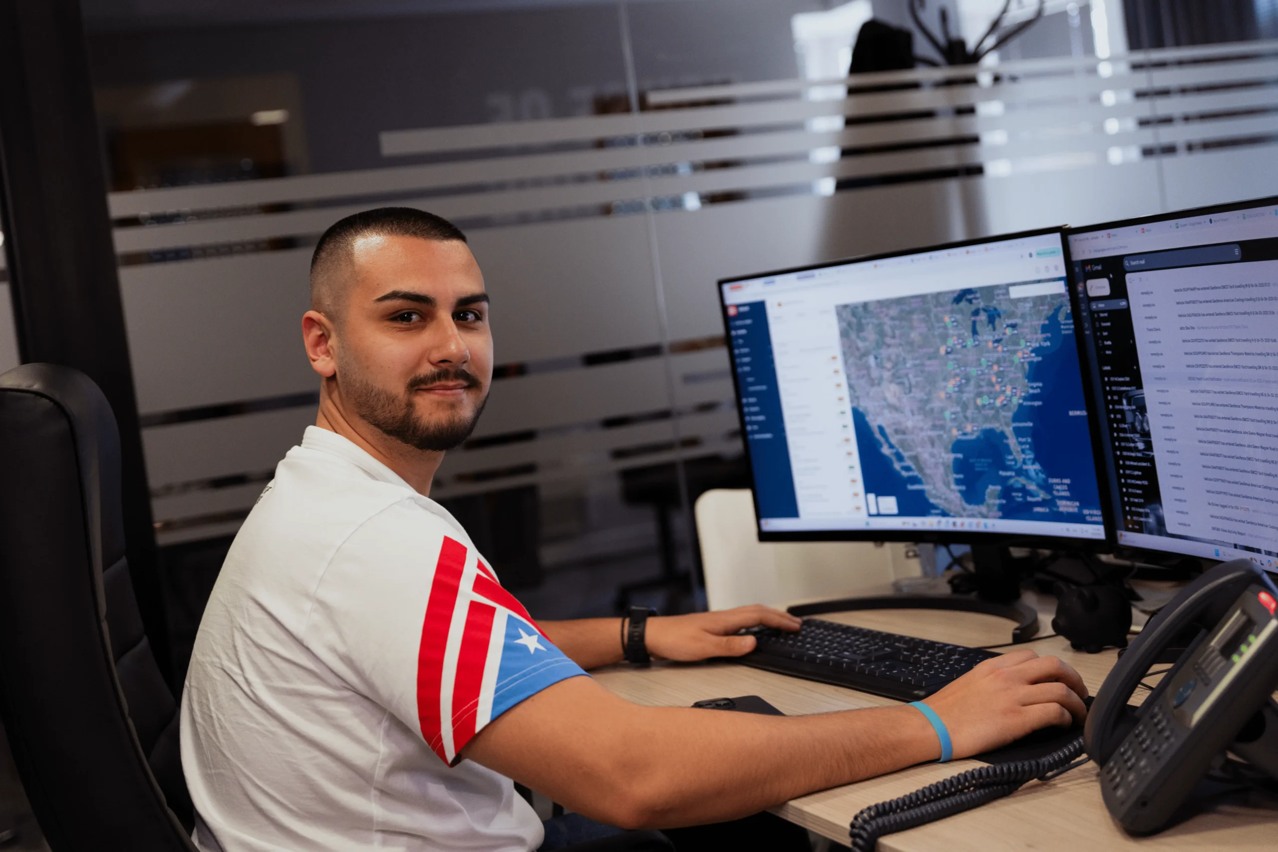 House of Trucking safety officer monitoring routes on dual monitors
