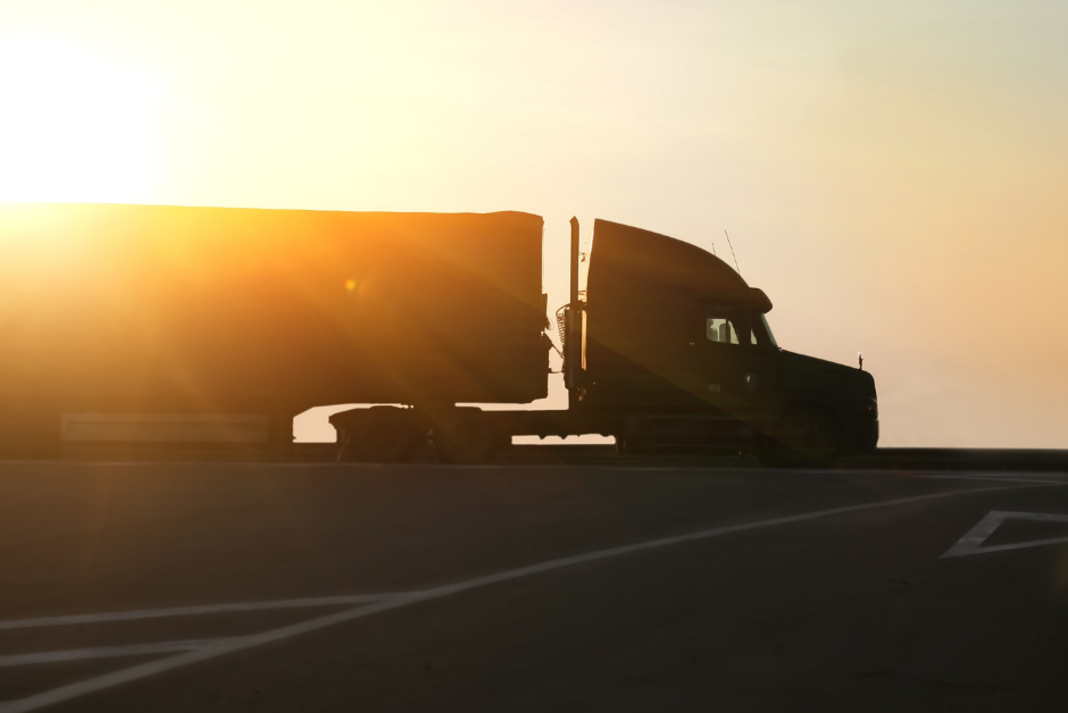 Semi-truck driving at sunset symbolizing local dispatch services