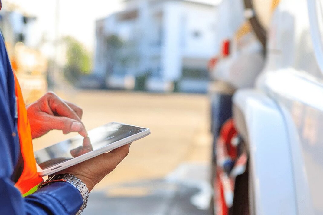 Truck driver using a tablet to complete MCS-150 form digitally