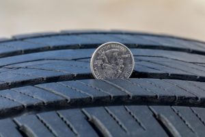 Quarter test to measure tire tread depth for DOT compliance